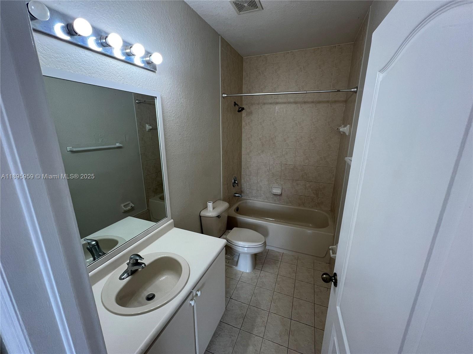2903 Southeast 17th Avenue, Unit 201 Homestead, FL 33035 - Photo 31 of 42 a bathroom with a sink a toilet and shower