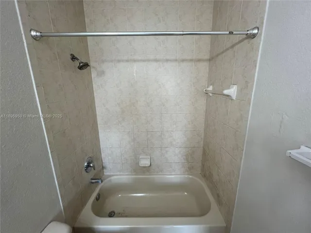 a bath tub sitting in a bathroom and shower
