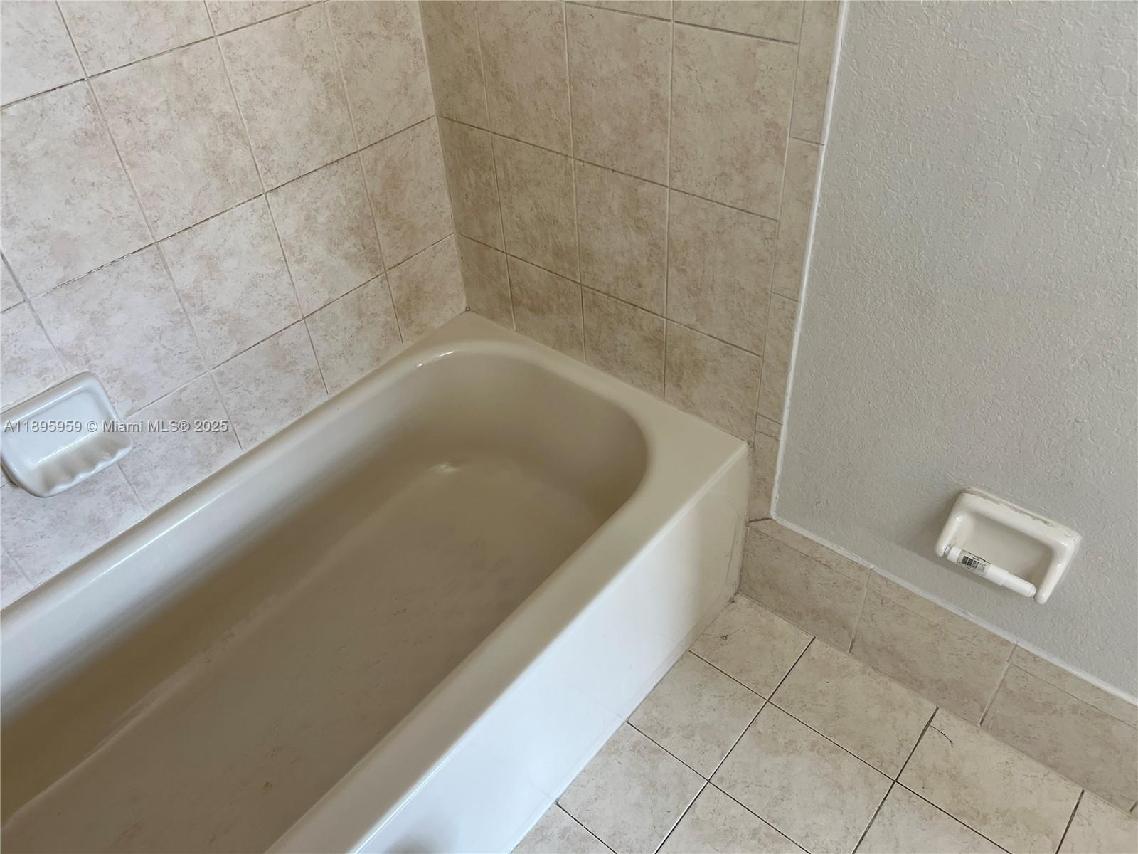 2903 Southeast 17th Avenue, Unit 201 Homestead, FL 33035 - Photo 34 of 42 a bath tub sitting in a bathroom and shower