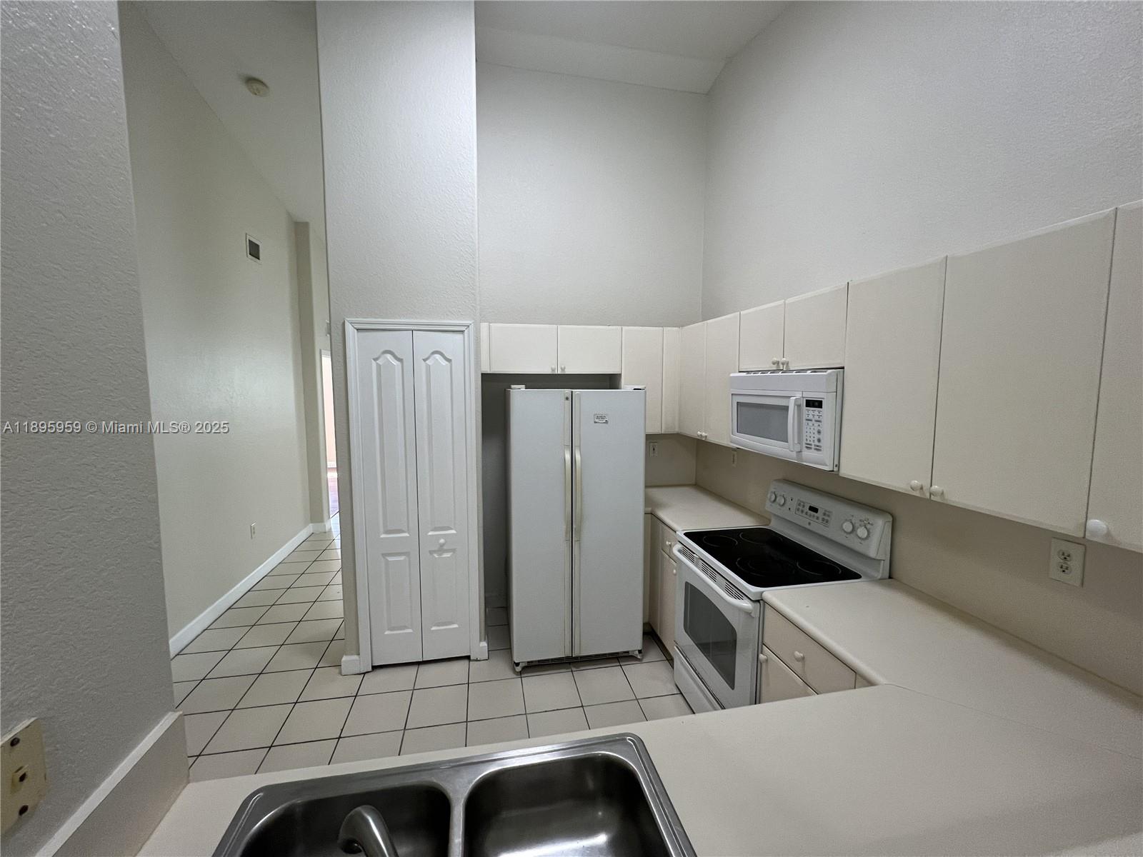 2903 Southeast 17th Avenue, Unit 201 Homestead, FL 33035 - Photo 10 of 42 a kitchen with stainless steel appliances cabinets and a counter top space