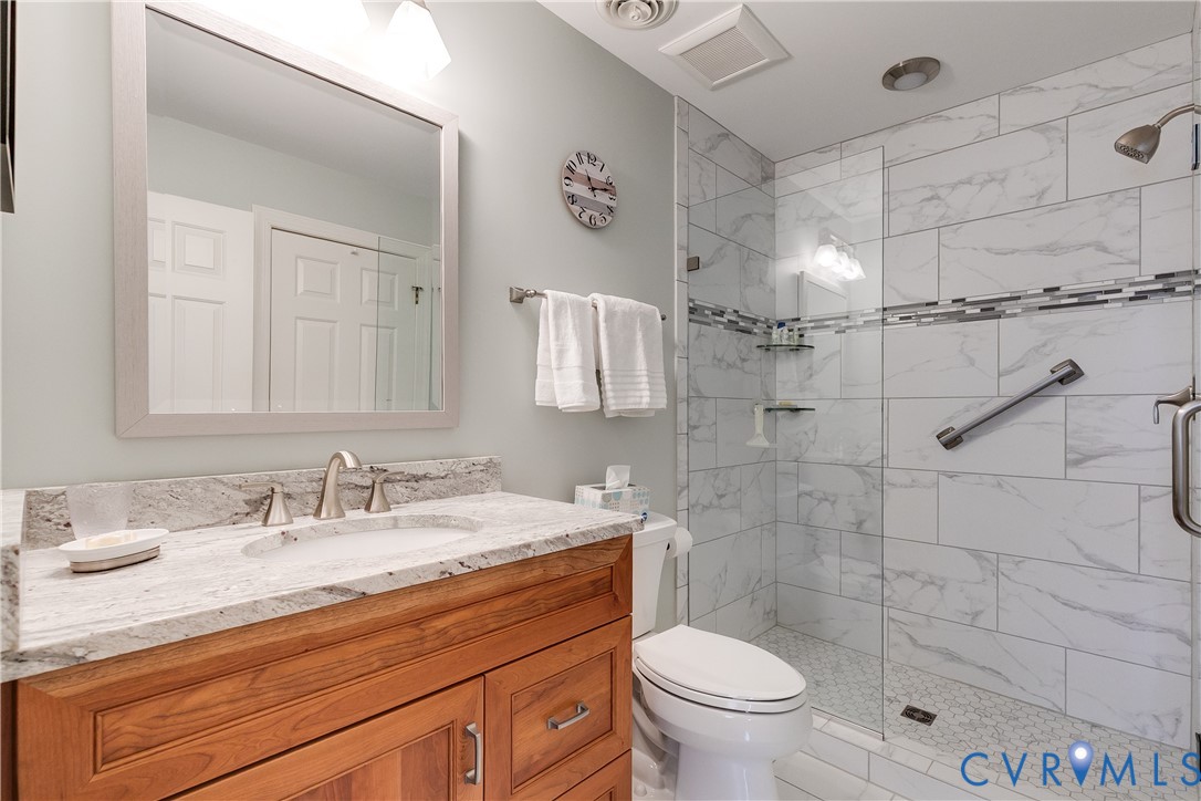 498 St Albans Way Henrico, VA 23229 - Photo 34 of 46 a bathroom with a granite countertop sink a toilet and mirror