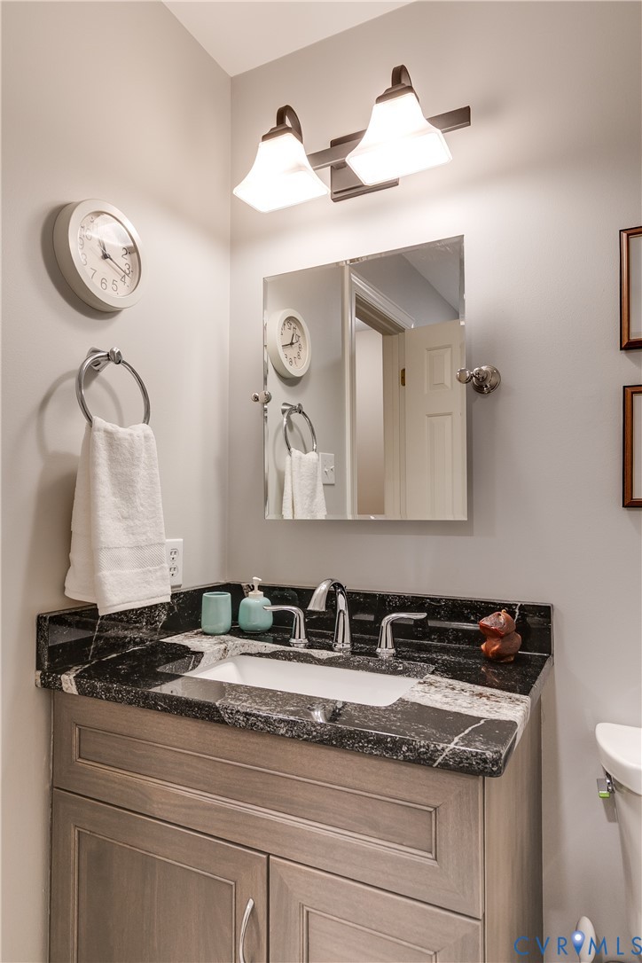 498 St Albans Way Henrico, VA 23229 - Photo 39 of 46 a bathroom with a granite countertop sink and a mirror