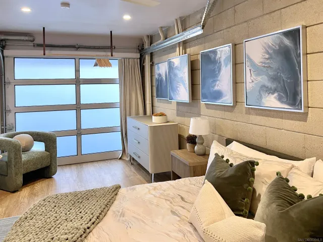 a bedroom with a bed and flat screen tv