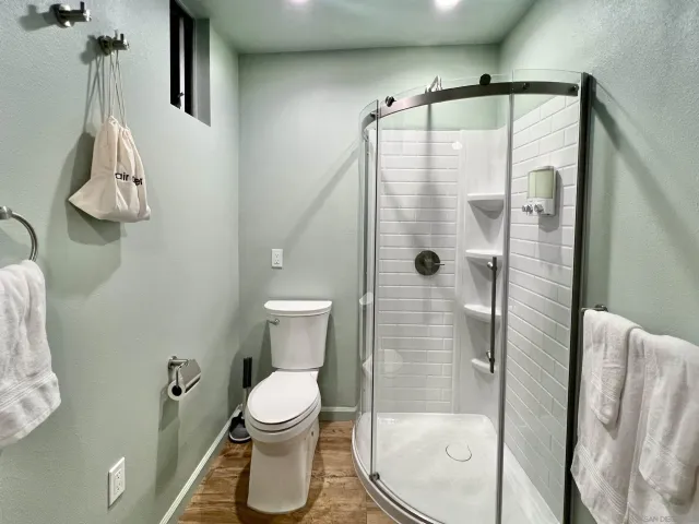 a bathroom with a toilet and a shower