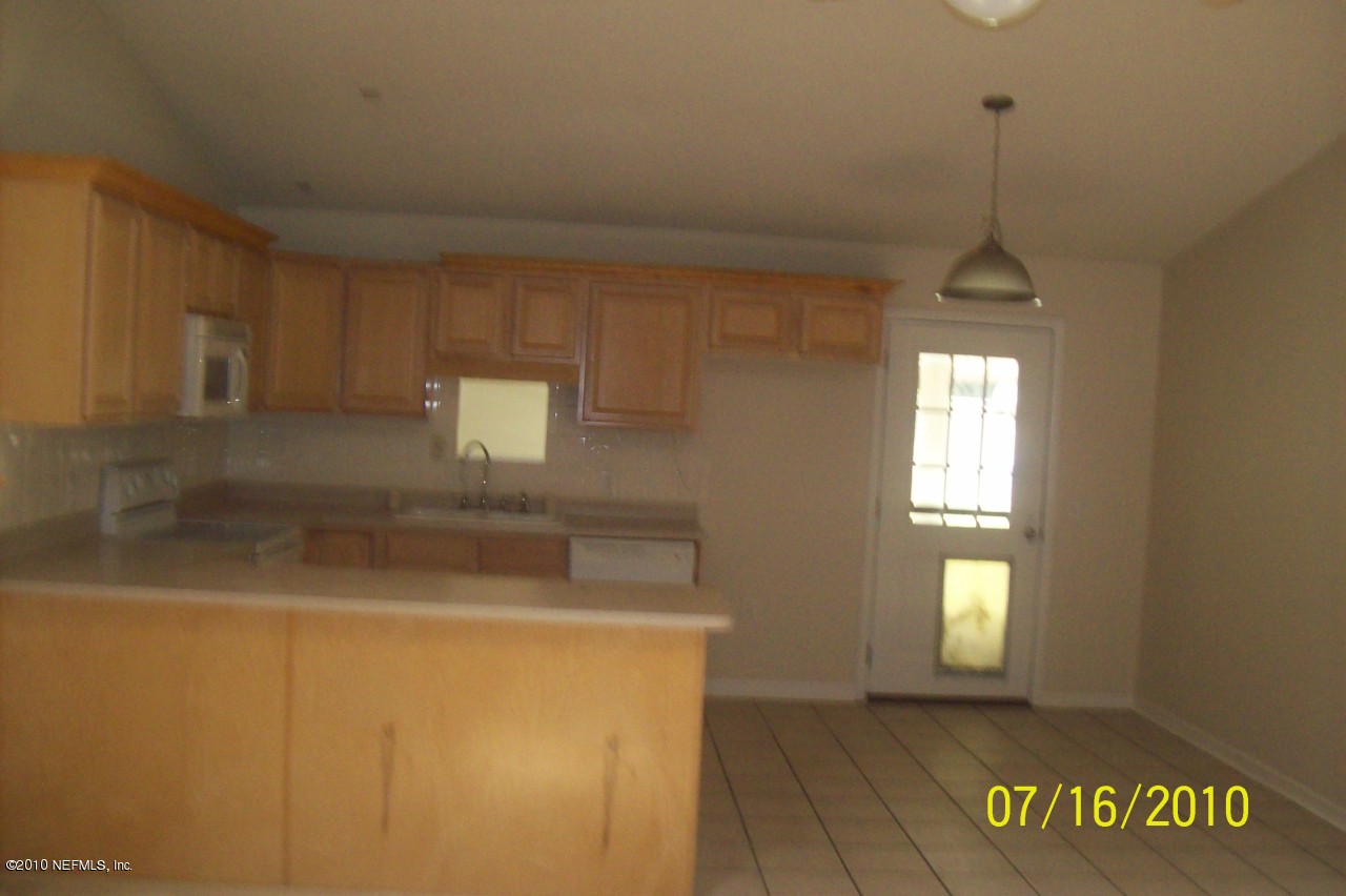 12900 Attrill Road Jacksonville, FL 32258 - Photo 2 of 7 a view of hallway with window and stairs