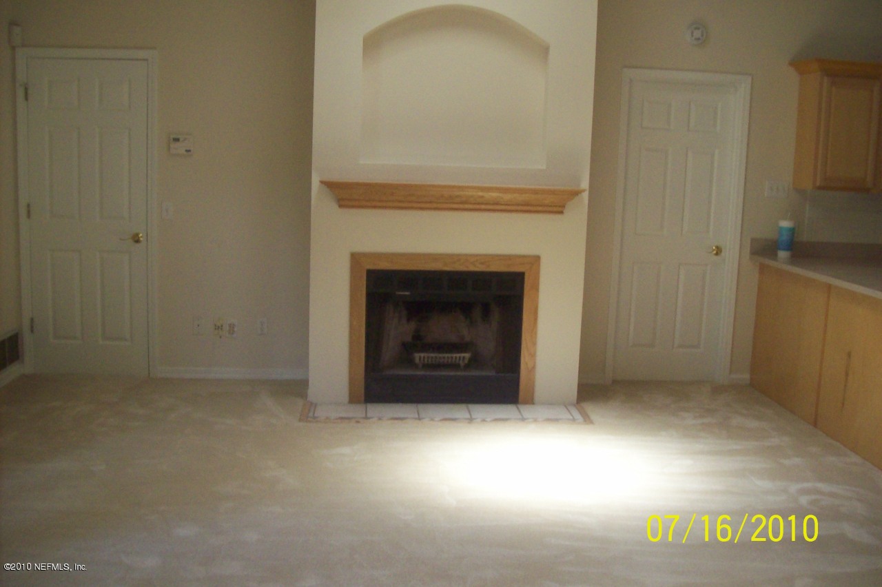 12900 Attrill Road Jacksonville, FL 32258 - Photo 3 of 7 a view of an empty room with a fireplace