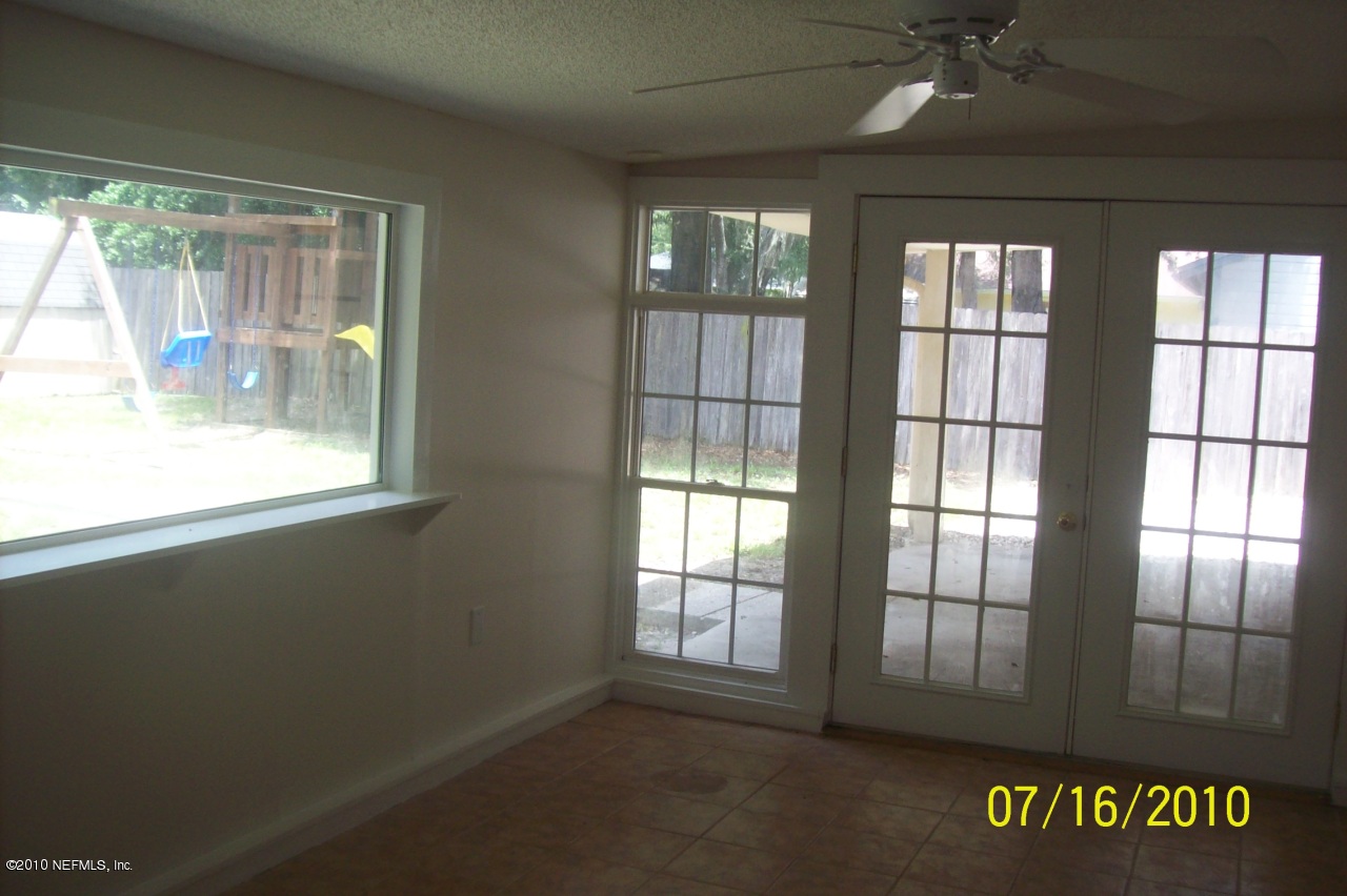 12900 Attrill Road Jacksonville, FL 32258 - Photo 6 of 7 an empty room with windows