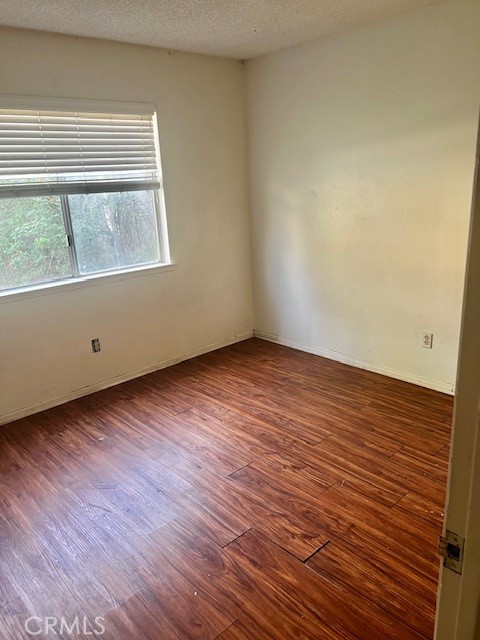 5110 Caldera Court Riverside, CA 92507 - Photo 17 of 28 a view of an empty room with wooden floor and a window