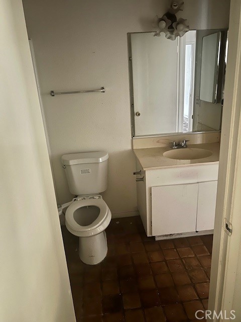 5110 Caldera Court Riverside, CA 92507 - Photo 20 of 28 a bathroom with a granite countertop toilet sink and mirror
