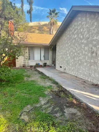 a backyard of a house with table and chairs