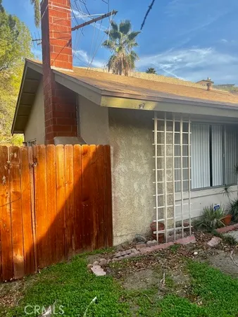a view of a house with a backyard and a window