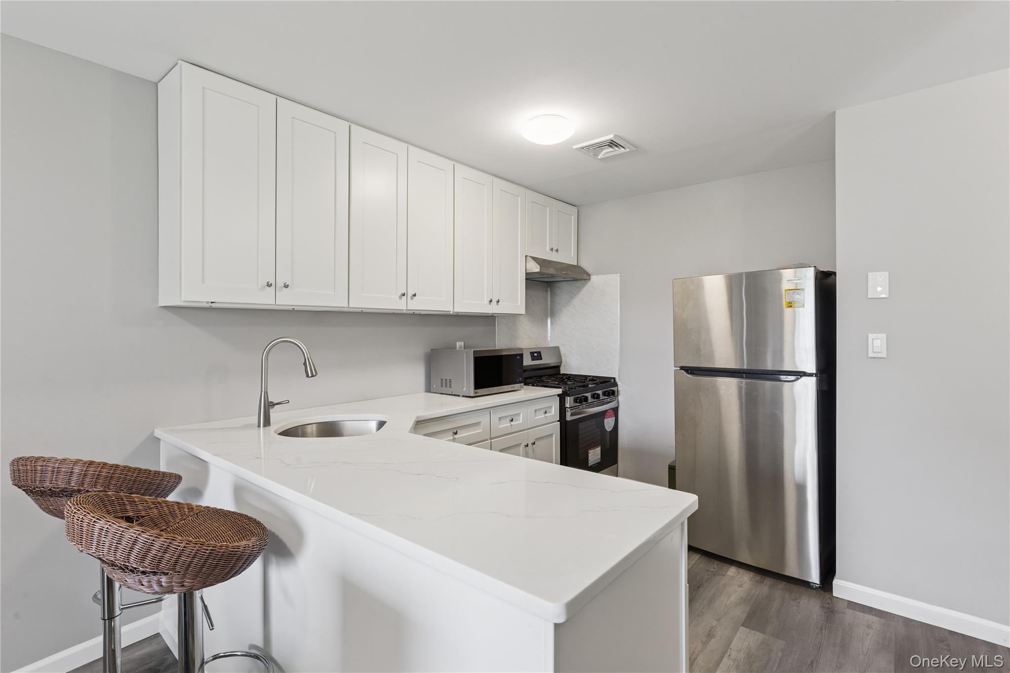 241 Fairview Circle Middle Island, NY 11953 - Photo 1 of 24 a kitchen with stainless steel appliances granite countertop a refrigerator a sink a stove a dining table and chairs