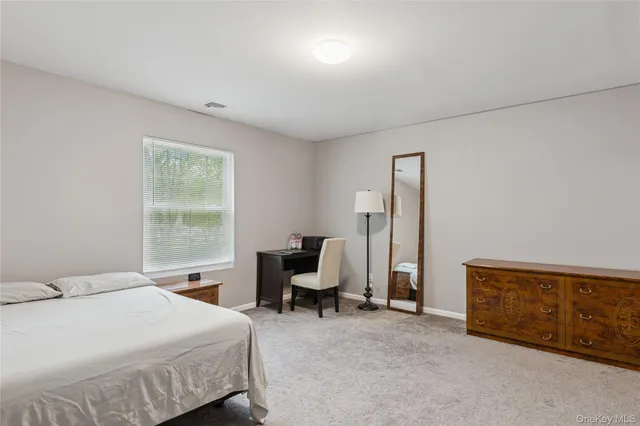 a bedroom with a bed and a chair