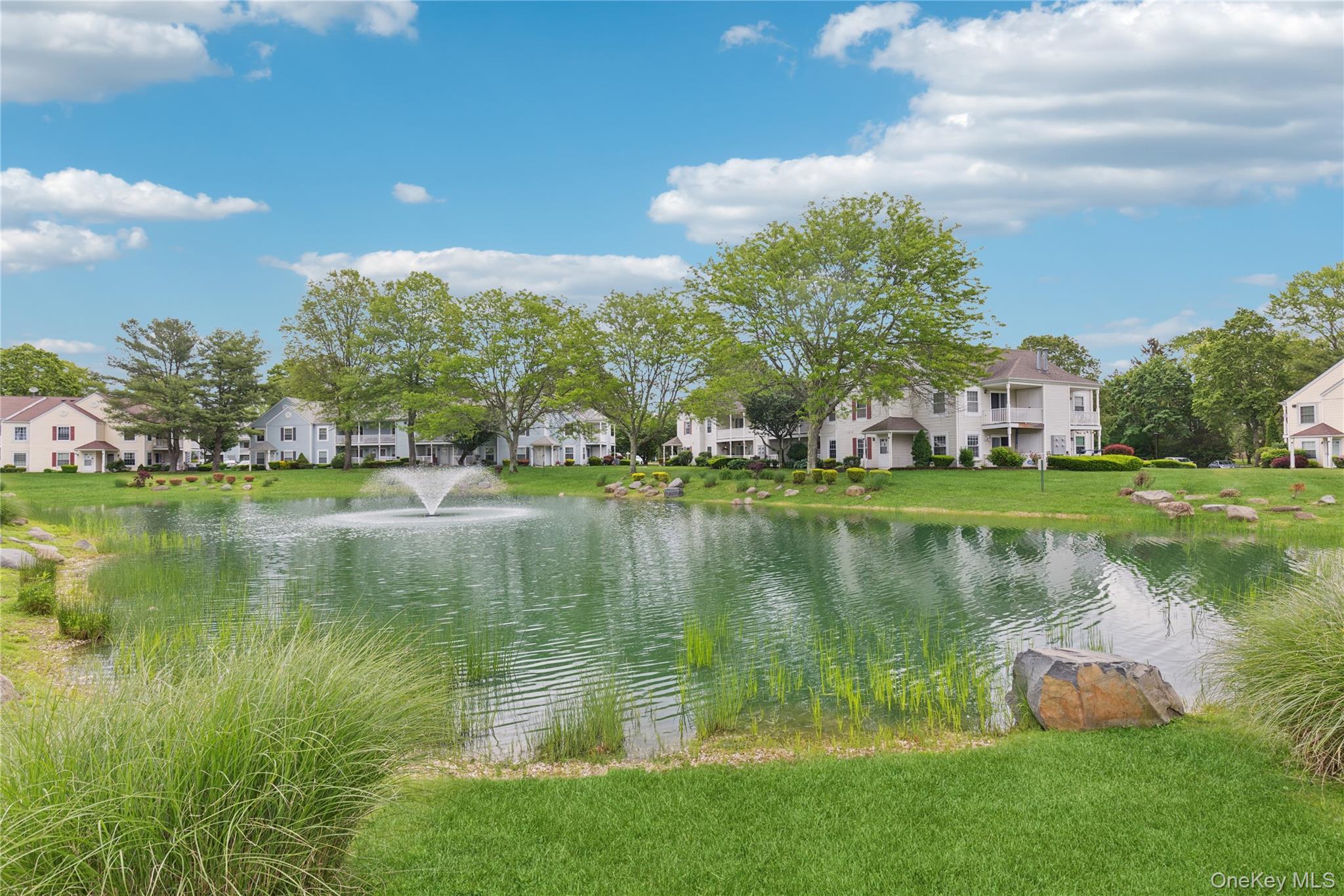 241 Fairview Circle Middle Island, NY 11953 - Photo 18 of 24 a view of a lake with a building in the background