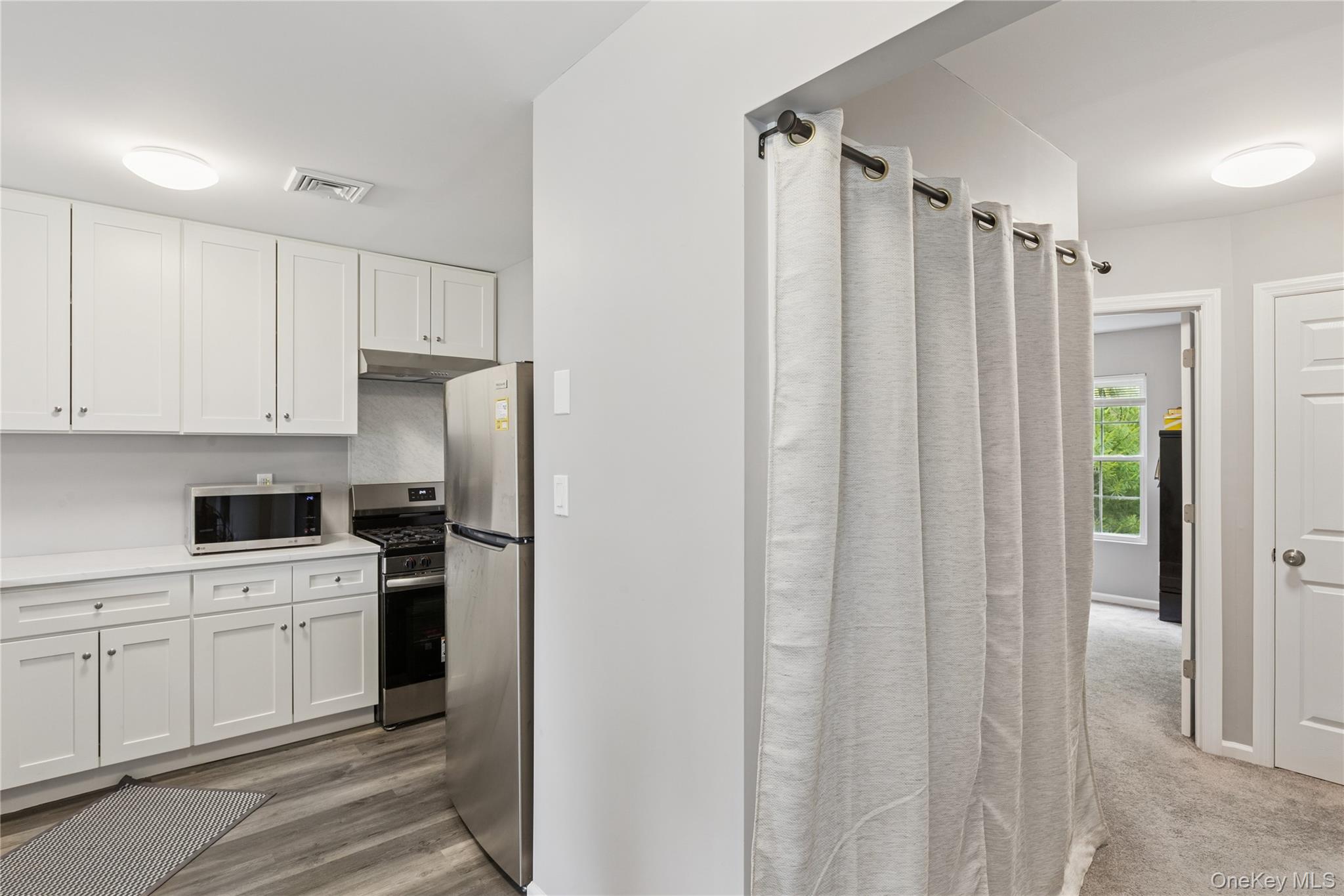 241 Fairview Circle Middle Island, NY 11953 - Photo 9 of 24 a kitchen with a refrigerator sink and cabinets