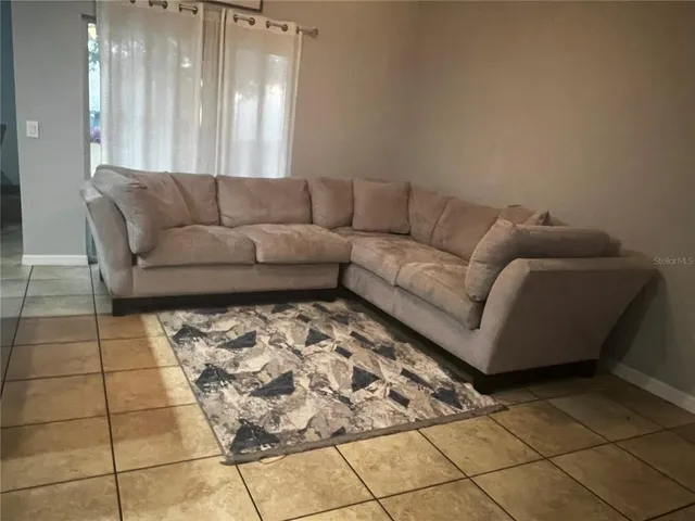 a living room with a couch and a rug