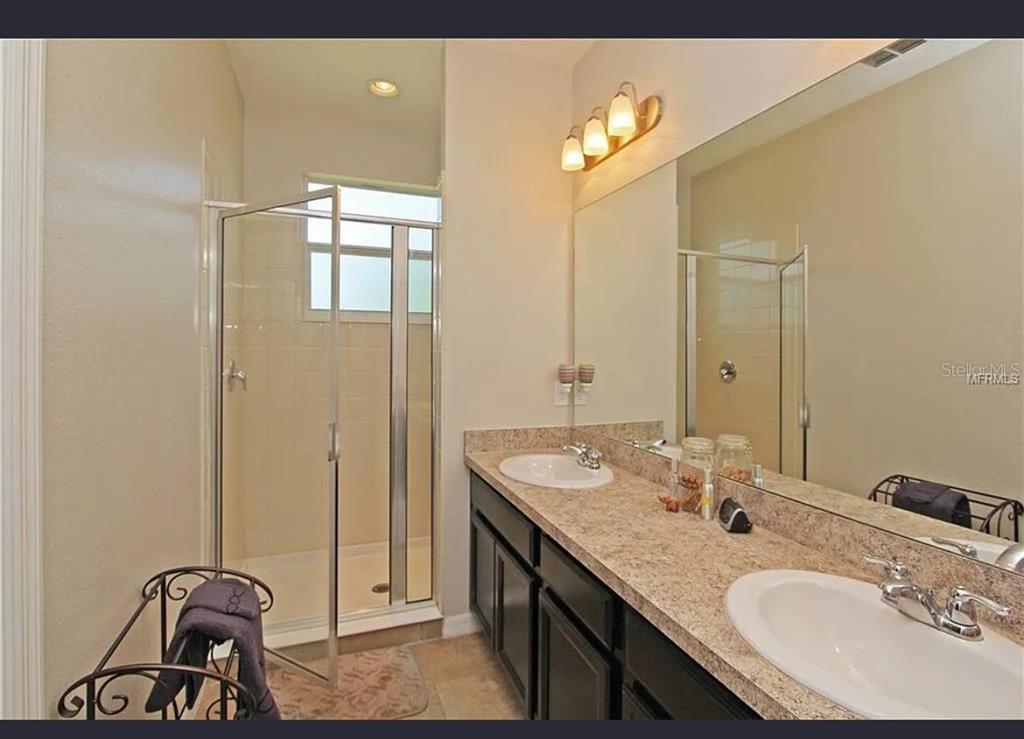 Undisclosed Address Ocoee, FL 34761 - Photo 6 of 7 a bathroom with a sink and a mirror