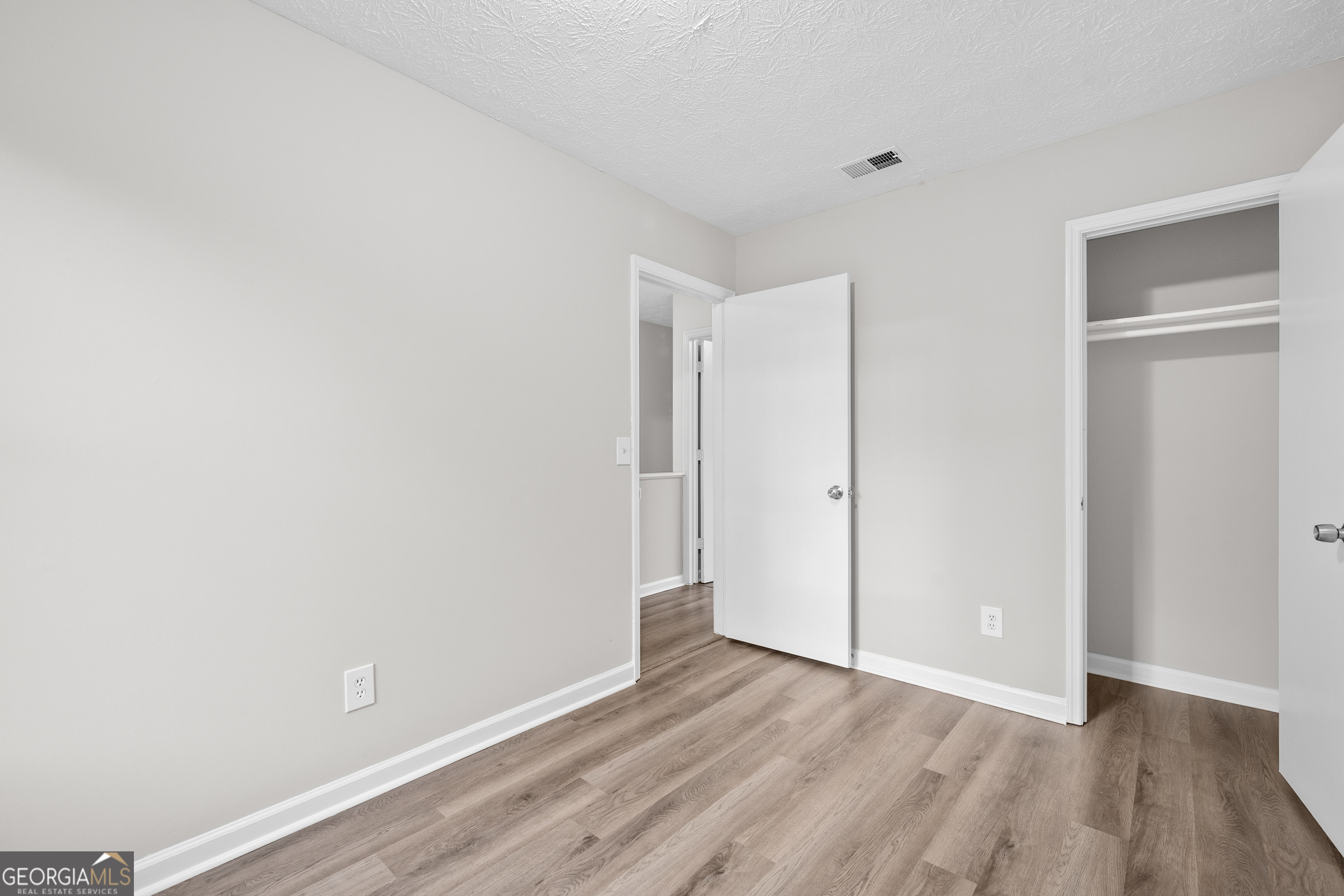 6706 Bent Creek Drive Rex, GA 30273 - Photo 14 of 27 a view of an empty room with wooden floor
