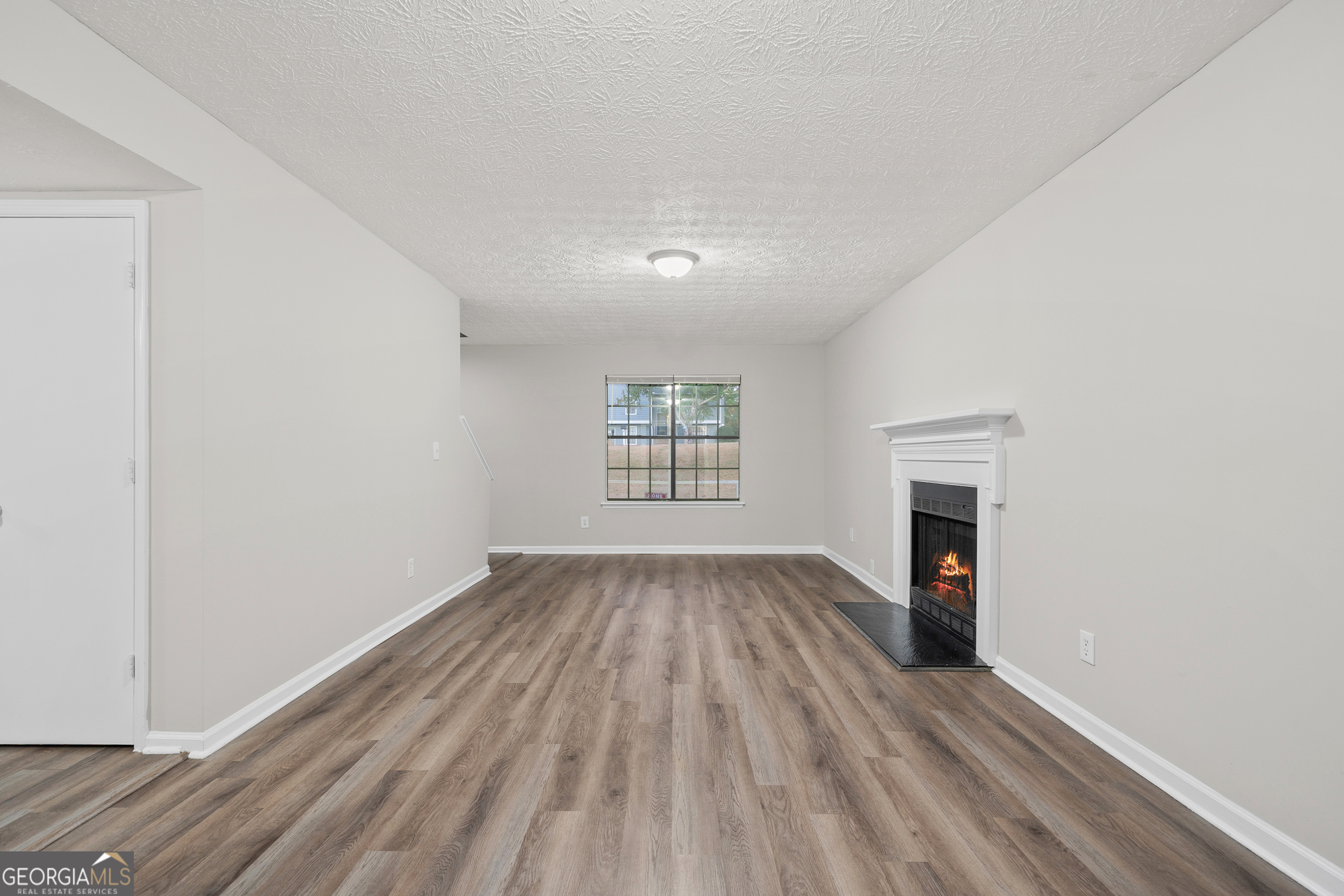 6706 Bent Creek Drive Rex, GA 30273 - Photo 19 of 27 a view of empty room with wooden floor and fireplace
