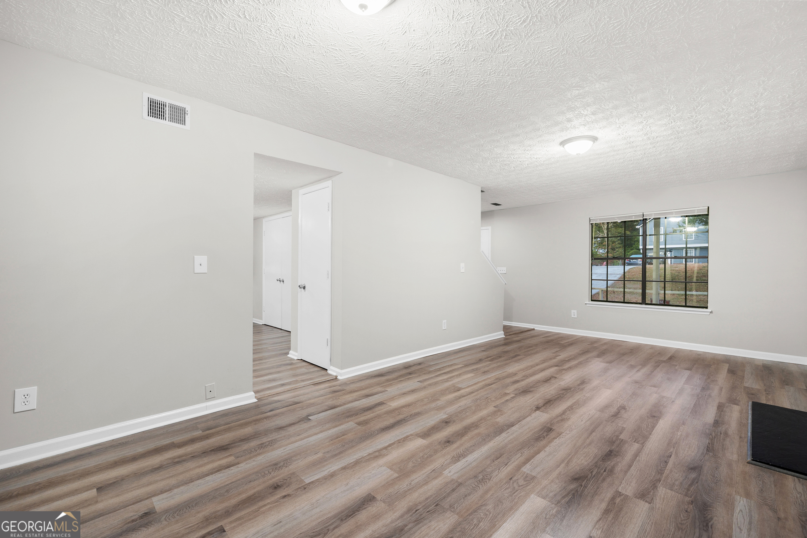 6706 Bent Creek Drive Rex, GA 30273 - Photo 20 of 27 wooden floor in an empty room with a window
