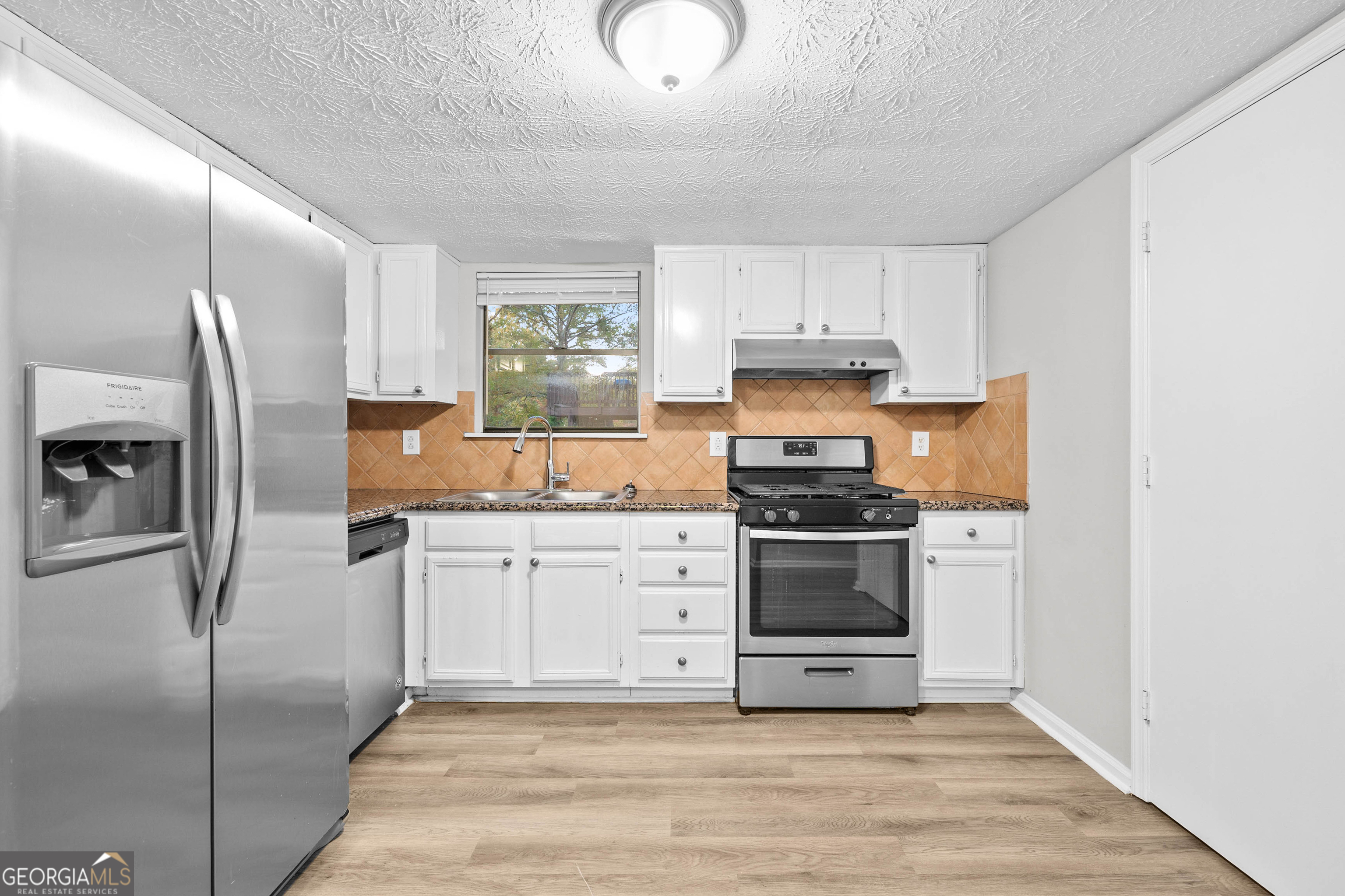 6706 Bent Creek Drive Rex, GA 30273 - Photo 2 of 27 a kitchen with granite countertop a refrigerator stove and sink