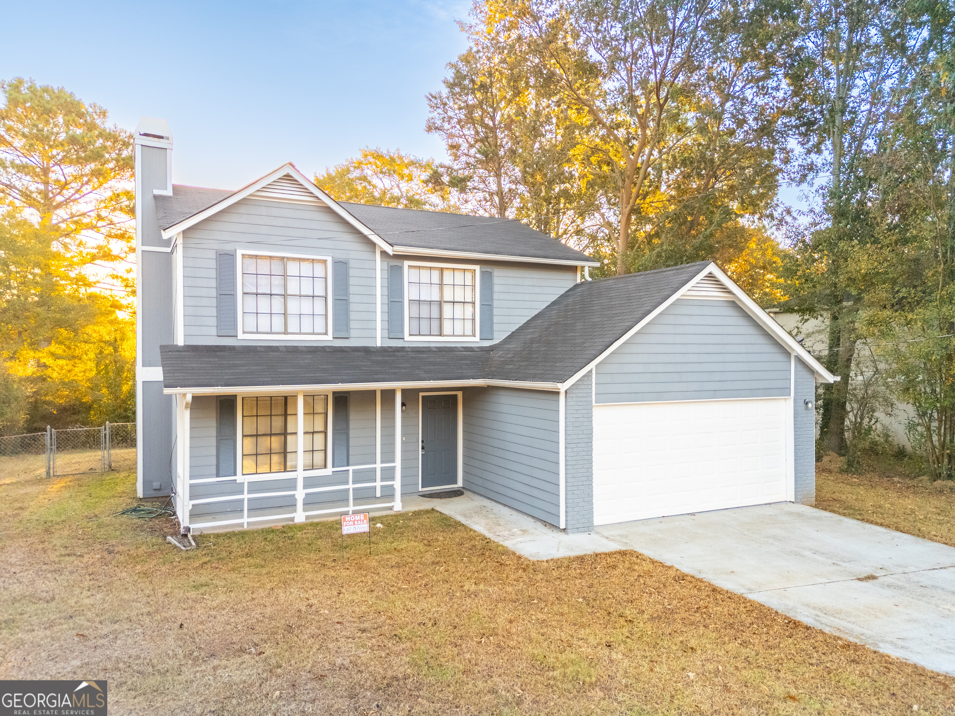 6706 Bent Creek Drive Rex, GA 30273 - Photo 24 of 27 a front view of a house with a yard and garage