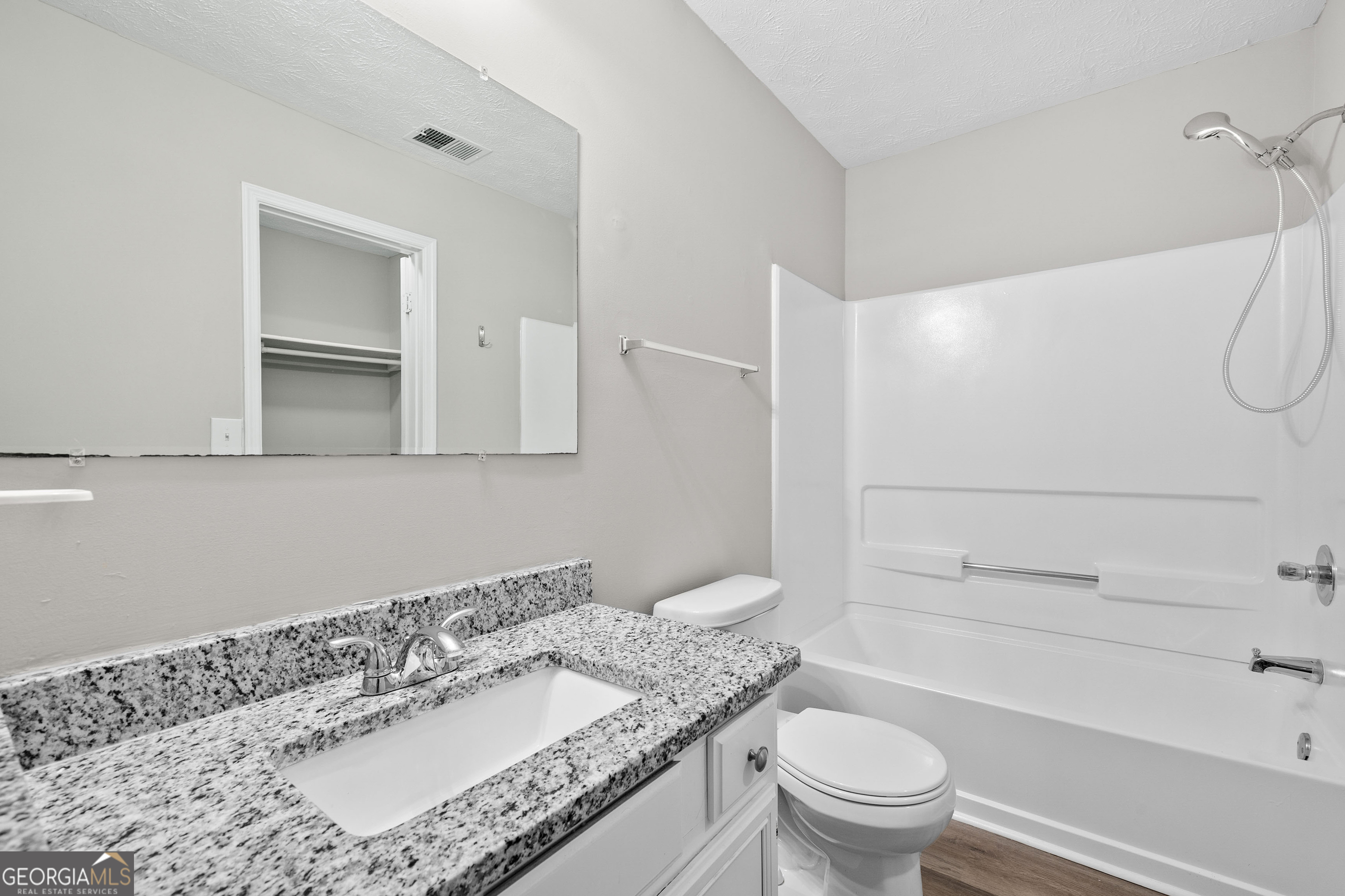 6706 Bent Creek Drive Rex, GA 30273 - Photo 9 of 27 a bathroom with a granite countertop sink a toilet and a bathtub