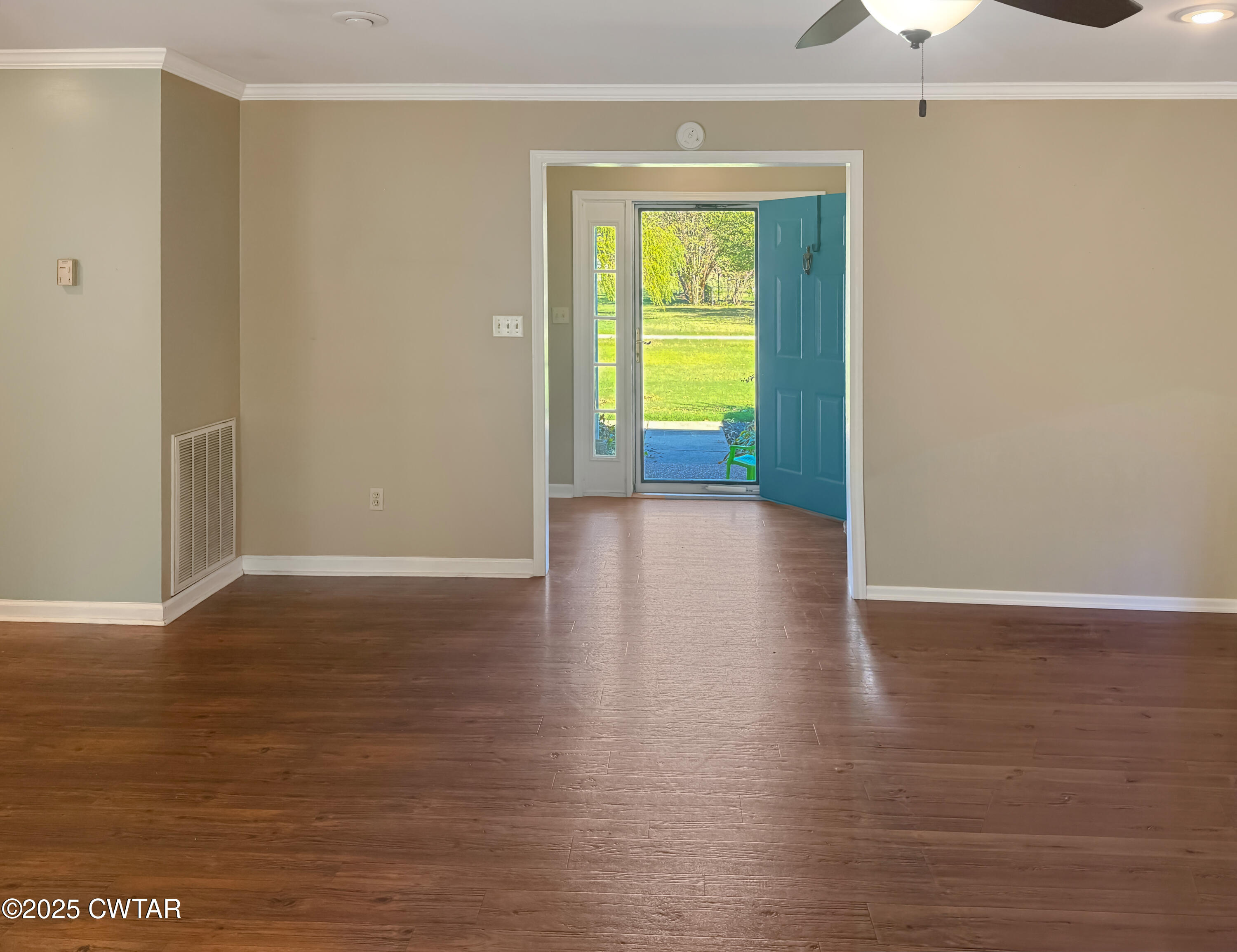 45 Village Avenue Ripley, TN 38063 - Photo 5 of 11 a view of a room with wooden floor and a ceiling fan