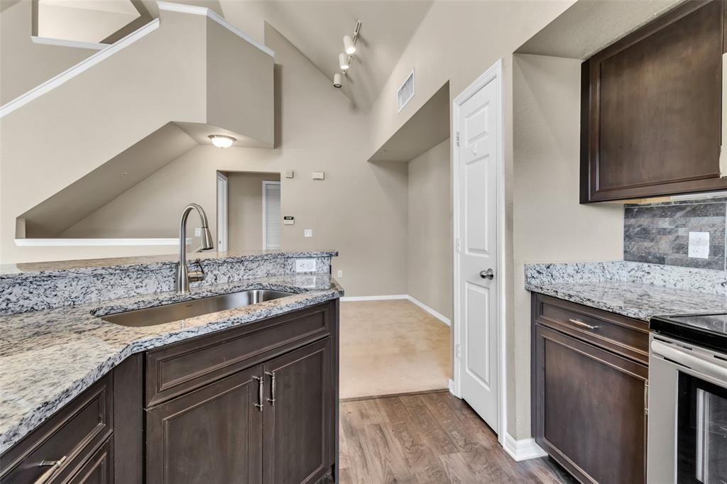 5511 Rosehill Road, Unit 203 Sarasota, FL 34233 - Photo 12 of 49 a kitchen with a granite countertop sink stainless steel appliances and a counter top space