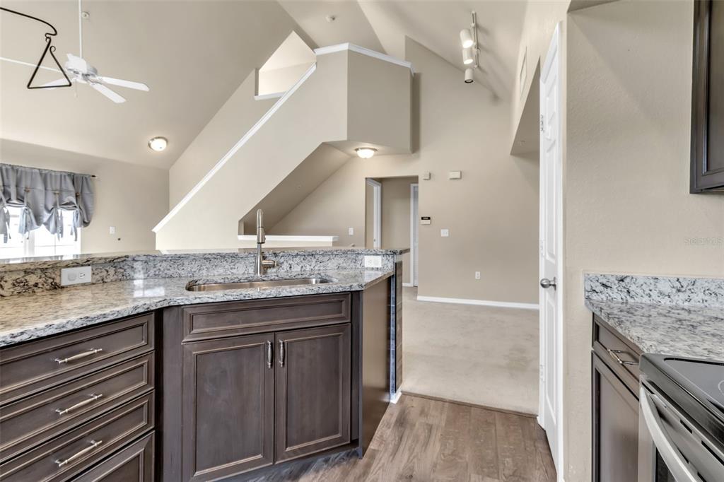 5511 Rosehill Road, Unit 203 Sarasota, FL 34233 - Photo 13 of 49 a kitchen with granite countertop a sink and a stove