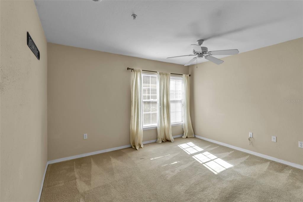 5511 Rosehill Road, Unit 203 Sarasota, FL 34233 - Photo 20 of 49 an empty room with windows and fan