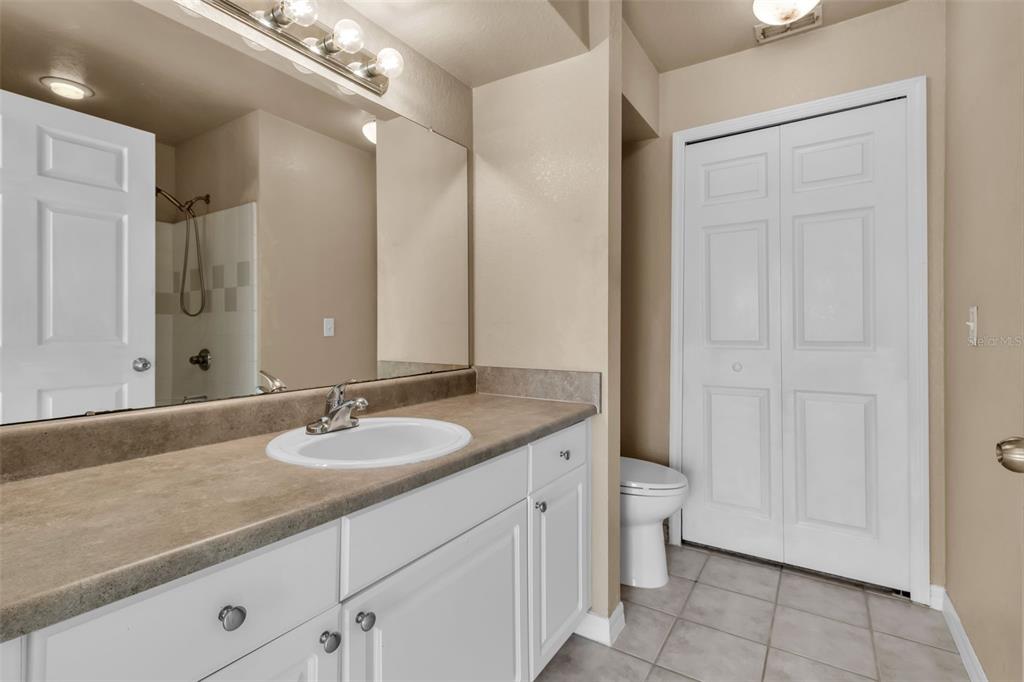 5511 Rosehill Road, Unit 203 Sarasota, FL 34233 - Photo 21 of 49 a bathroom with a granite countertop sink a toilet and a mirror