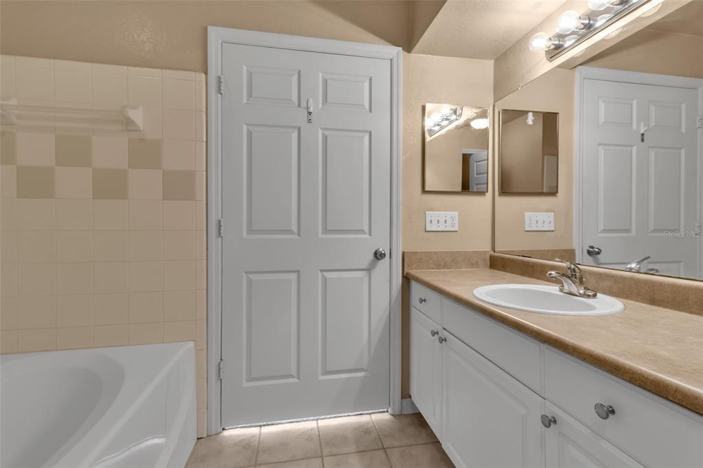 5511 Rosehill Road, Unit 203 Sarasota, FL 34233 - Photo 22 of 49 a bathroom with a granite countertop sink and a mirror