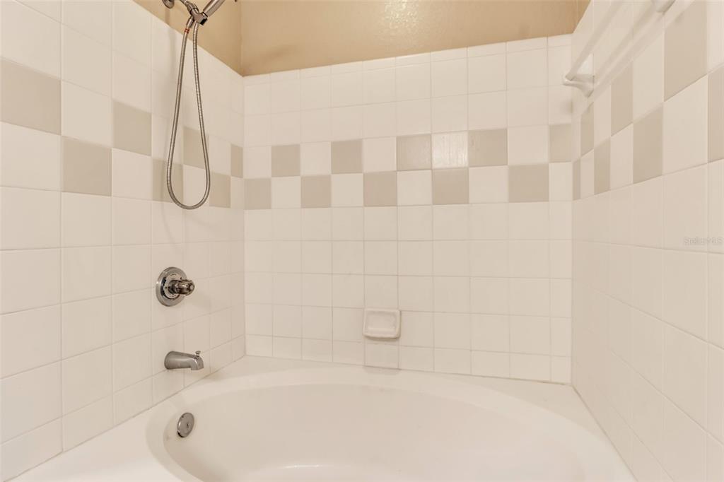 5511 Rosehill Road, Unit 203 Sarasota, FL 34233 - Photo 23 of 49 a bathroom with a bath tub with a shower