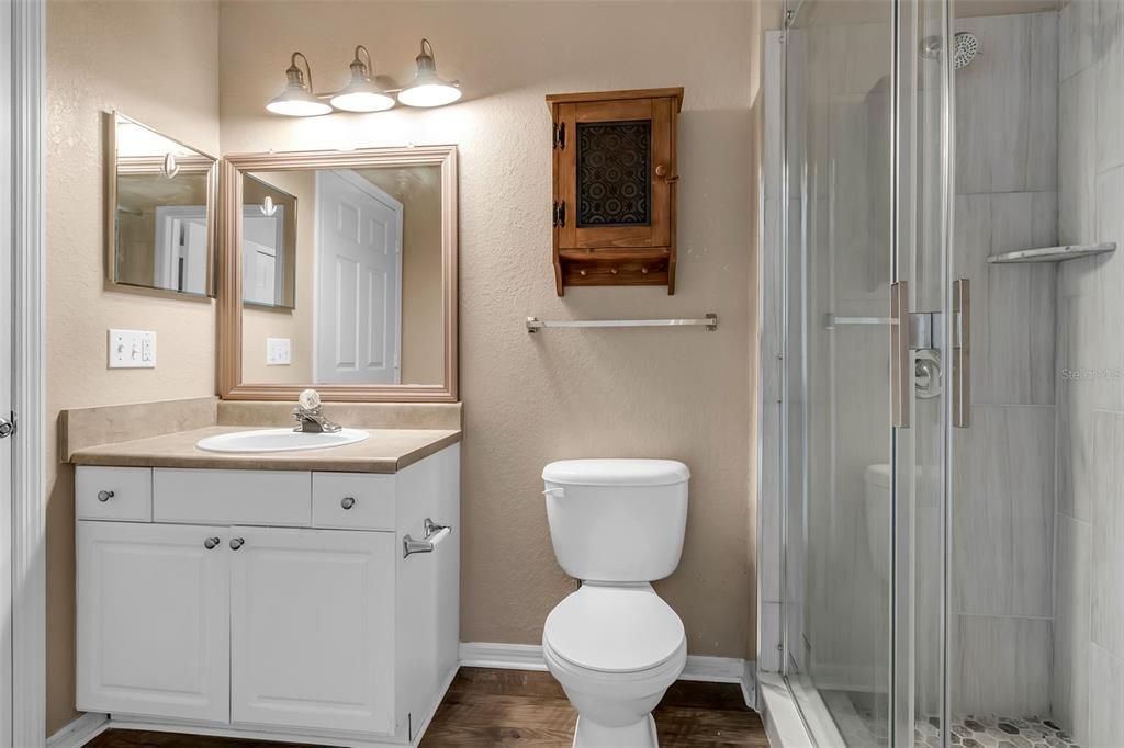 5511 Rosehill Road, Unit 203 Sarasota, FL 34233 - Photo 27 of 49 a bathroom with a toilet sink and mirror