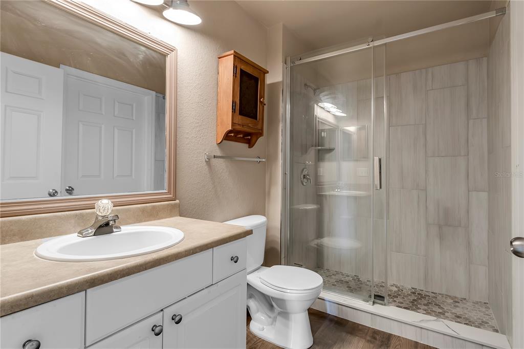 5511 Rosehill Road, Unit 203 Sarasota, FL 34233 - Photo 28 of 49 a bathroom with a sink toilet a mirror and shower