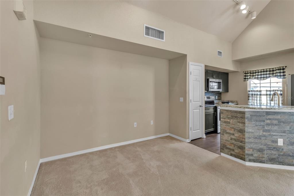 5511 Rosehill Road, Unit 203 Sarasota, FL 34233 - Photo 9 of 49 a view of kitchen with refrigerator and window