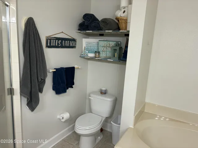 a view of a porch with a table and chairs