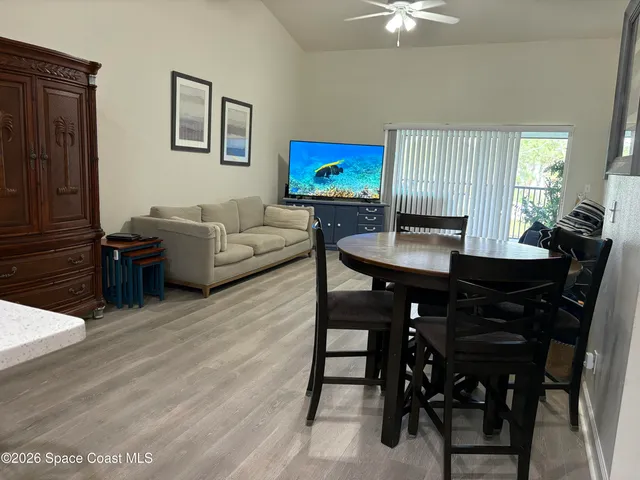 a kitchen with a sink a microwave a window and cabinets