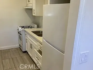 a kitchen with a stove and a white cabinet