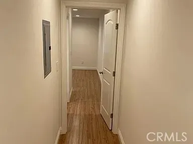 an empty room with wooden floor and sliding door