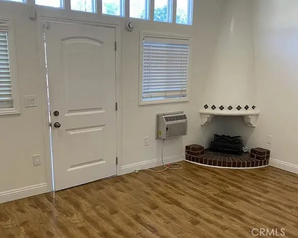 a room with wooden floor and shoes