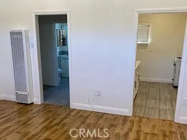 an empty room with wooden floor and closet