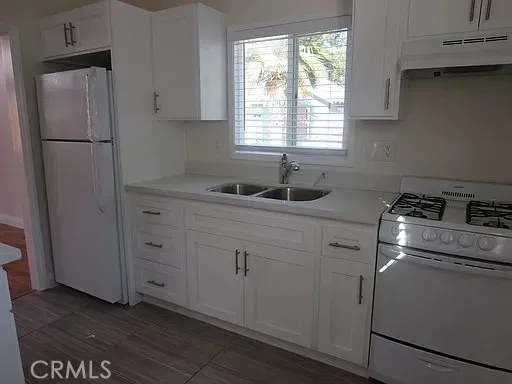 a kitchen with appliances cabinets and a window