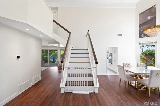 a view of entryway with wooden floor and stairs