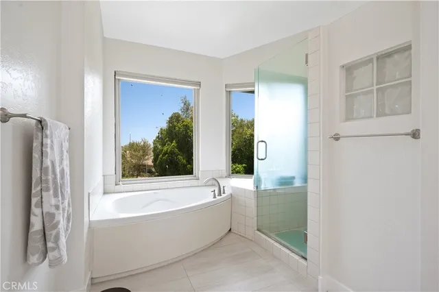 a bathroom with bathtub and shower