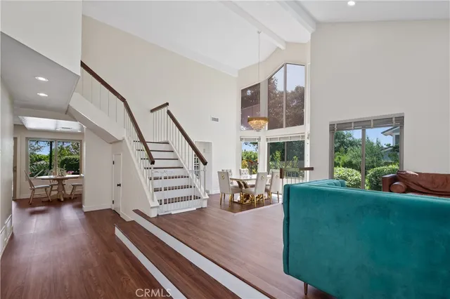 a view of a livingroom with furniture hardwood floor and staircase