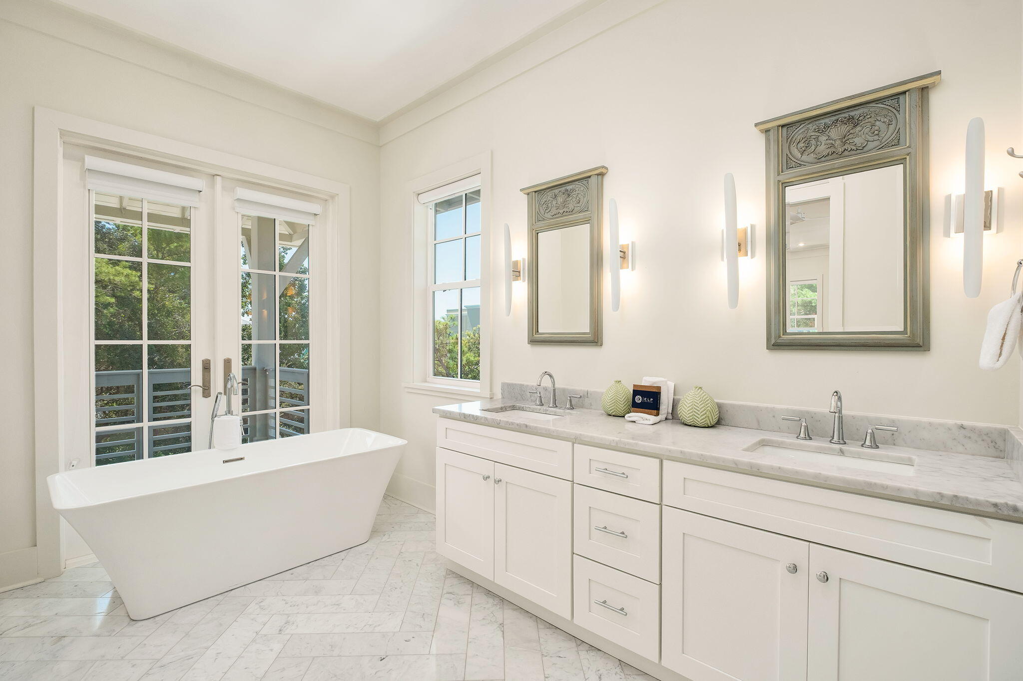 45 Mary Street Santa Rosa Beach, FL 32459 - Photo 28 of 46 a bathroom with double vanity sinks a mirror and a bathtub