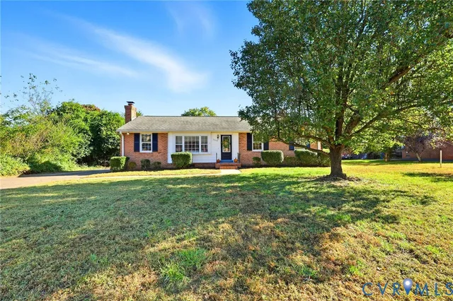 a front view of a house with yard and green space