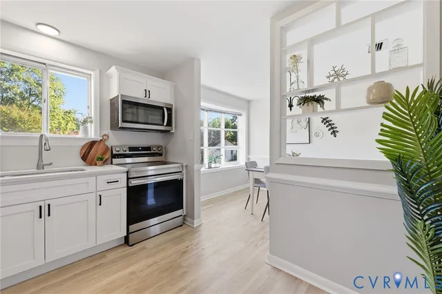 a kitchen with a white cabinets and appliances
